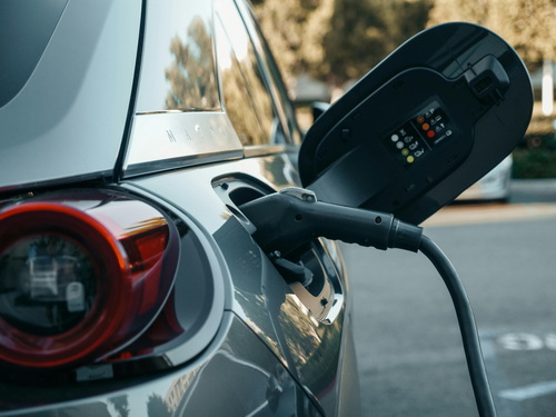 Electric car charging at futuristic station, representing the latest in electric vehicles 2025